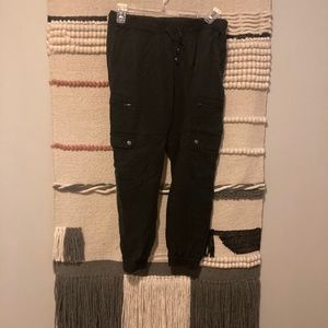 Black utility pants with gold accents